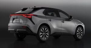 Rear angle of a silver Toyota bZ, featuring sleek taillights and alloy wheels.
