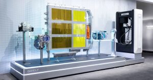 Display of Geely's 1000V EV architecture, showcasing battery and motor components in a showroom.