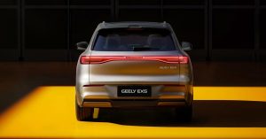 Rear view of a silver Geely EX5 with distinctive taillights, set in a showroom.