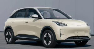 The image shows a side view of a cream-colored electric vehicle with sleek lines and black wheels.