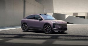 Side view of a purple Nio EC6, showcasing sleek design and sporty wheels in a modern setting.