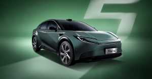 The image shows a front angle of the Toyota bZ5, featuring sleek lines and modern wheels.