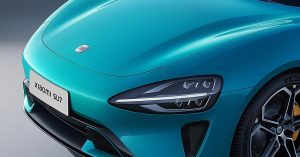 Close-up of the front, showcasing sleek headlights, turquoise paint, and distinctive logo.