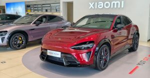 Red Xiaomi Yu7 GT displayed in a showroom, featuring sleek design and sporty wheels.