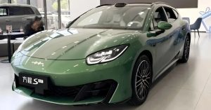 Green BYD Fang Cheng Bao Formula S GT in a showroom, showcasing sleek design and alloy wheels.