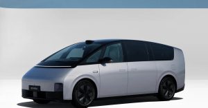 The image shows a side view of a sleek, modern electric vehicle with a smooth design and large wheels.