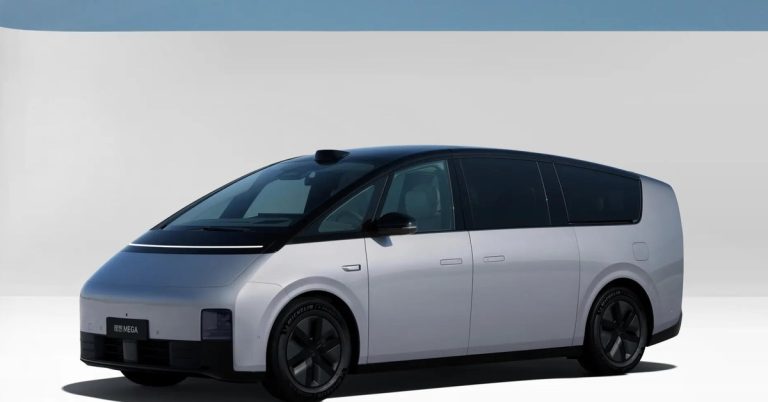 The image shows a side view of a sleek, modern electric vehicle with a smooth design and large wheels.