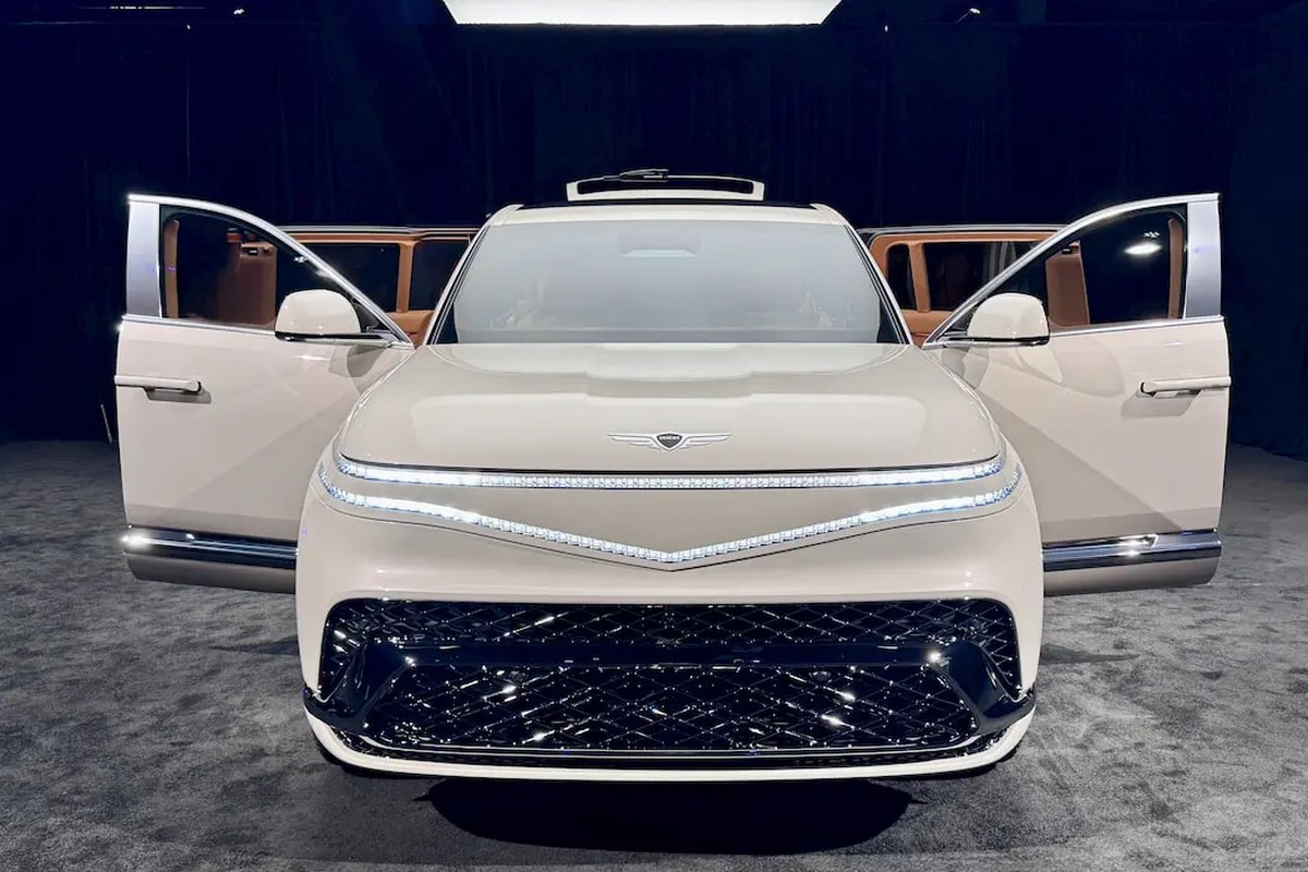 Front view of Genesis GV90 with open doors, showcasing sleek design and illuminated grille.
