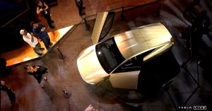 Tesla Cybercab displayed at an event, featuring open doors and a sleek design.