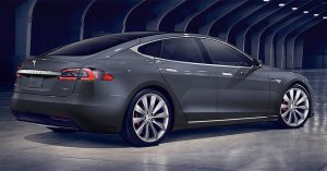 Rear angle of a Tesla Model S, showcasing sleek design, large wheels, and minimalistic lines.