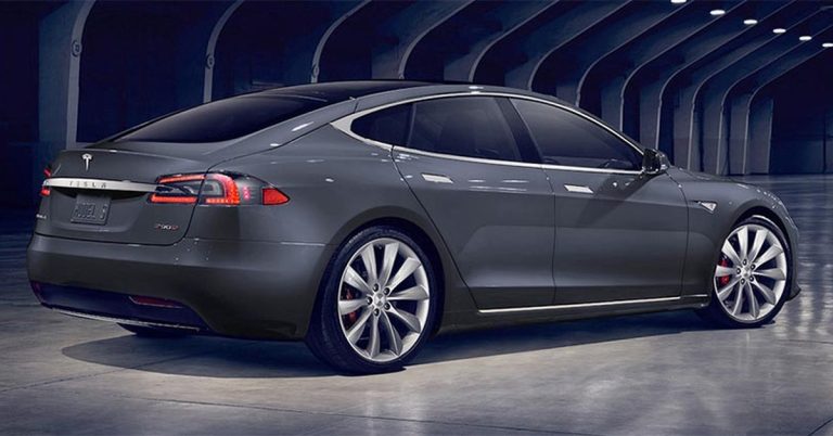 Rear angle of a Tesla Model S, showcasing sleek design, large wheels, and minimalistic lines.