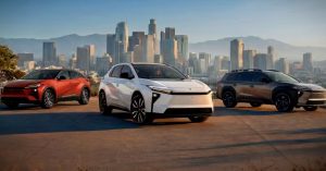 Three Toyota vehicles parked outdoors with a city skyline in the background.
