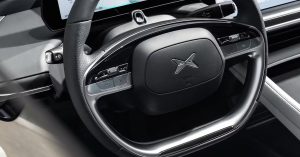 Interior view of Xpeng's dashboard featuring a steering wheel, controls, and digital display.