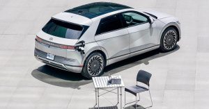 Hyundai IONIQ 5 parked, rear angle, charging port visible, modern wheels, minimalistic setting.