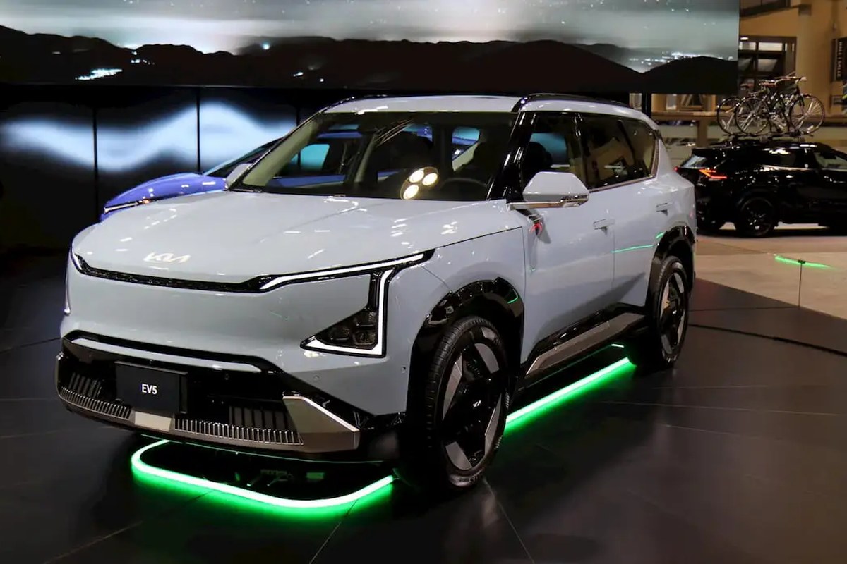 The Kia EV3 is displayed at an event, showcasing a sleek front angle with distinctive headlights and modern wheels.