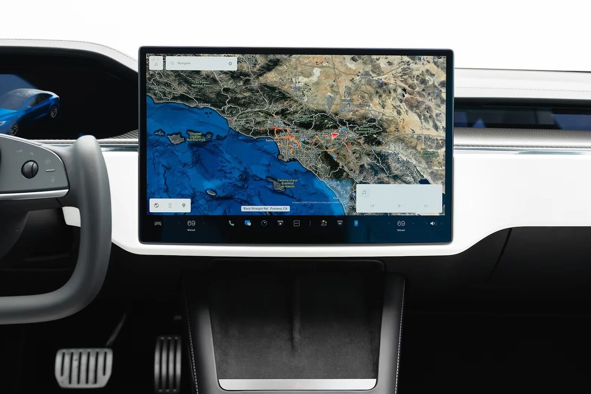 Interior view featuring a large touchscreen displaying navigation map and controls.