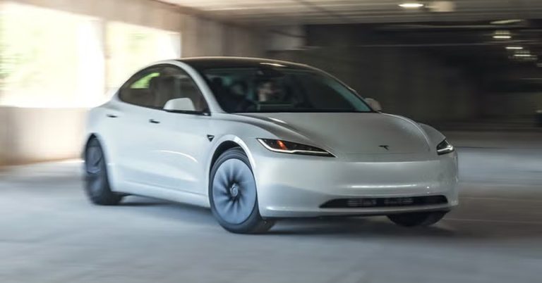 White Tesla EV in motion, side view, showcasing sleek design and dark wheels.